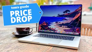 MacBook Pro 16-inch sitting on a patio table with deal tag